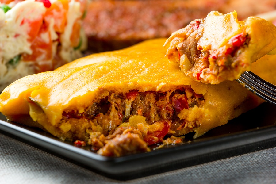 Tamale broken up to show inside of the maza and stuffing.